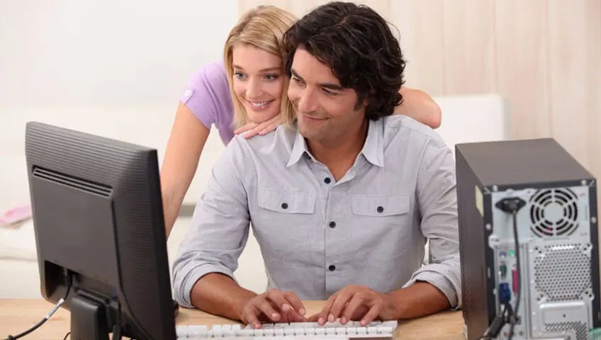 A couple at their home computer